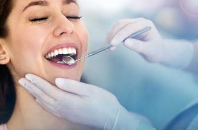 Woman getting dental exam at Sparkle Dental