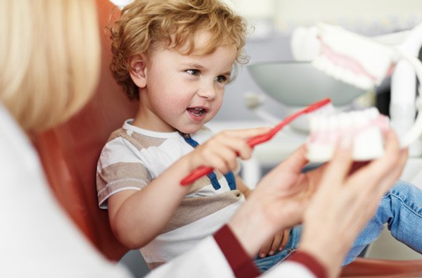 Little boy learning to brush teeth at Sparkle Dental in Dorchester, MA